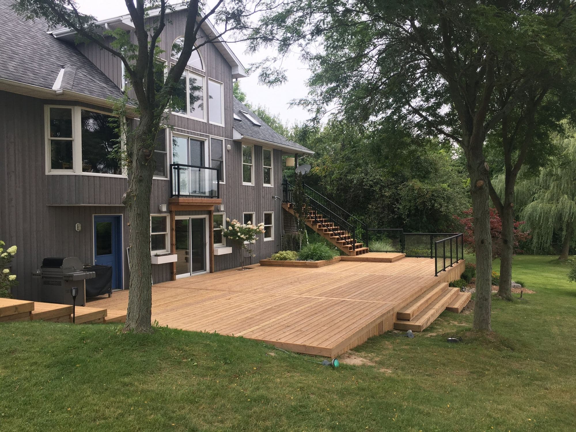 Large pressure-treated wood deck in a residential backyard
