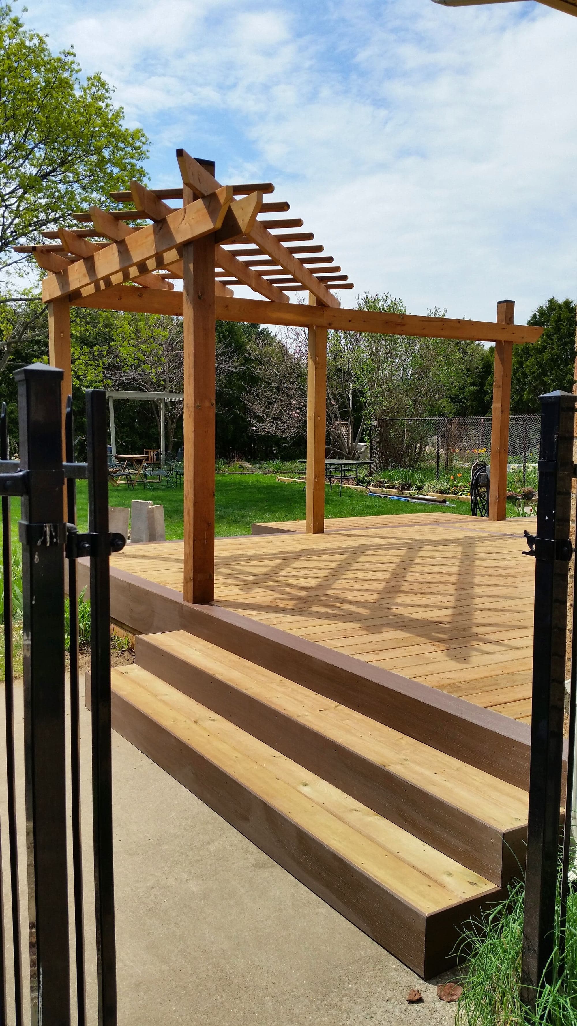 Wood pergola and deck in a residential backyard
