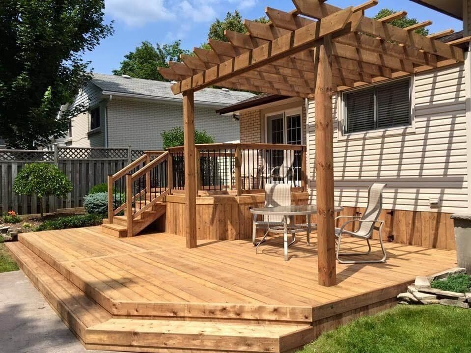 Wood deck and pergola built beside a home