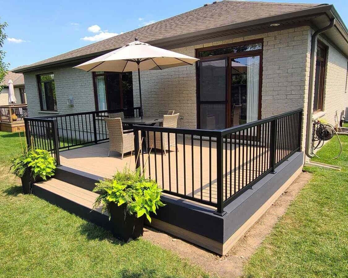 Backyard deck with dark picket railing