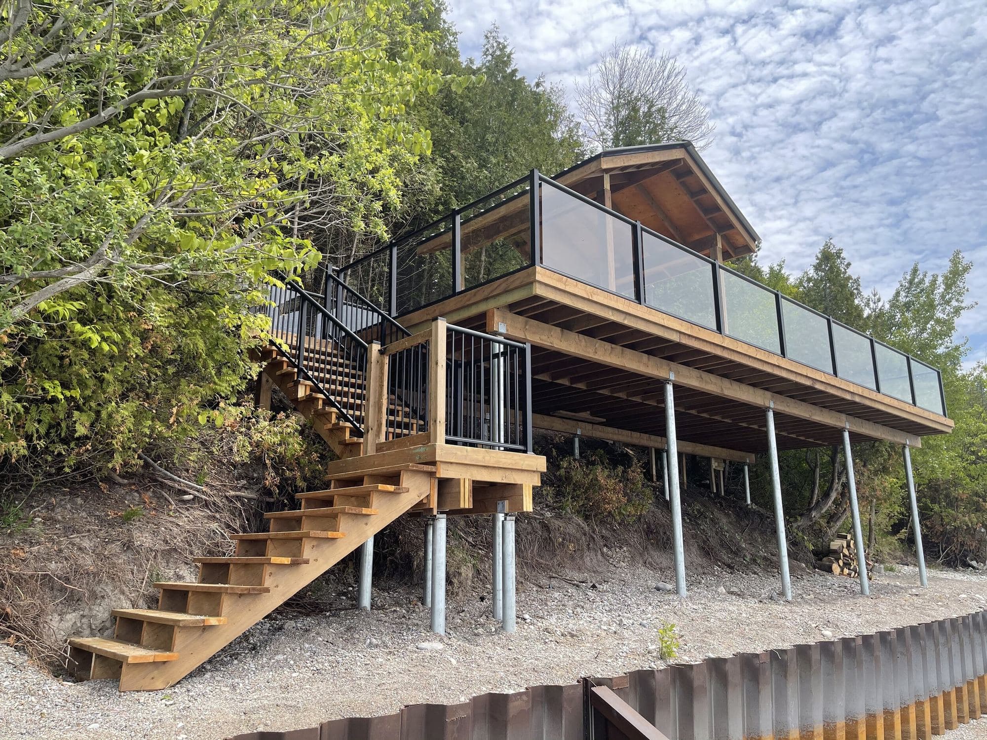 Raised backyard deck with railing built by Creative Custom Decks